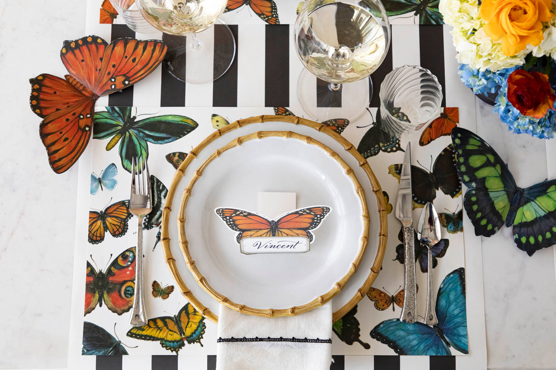 A variety of colorful butterflies displayed against a light background on Hester & Cook's Butterfly Flight Placemat made of FSC certified paper.