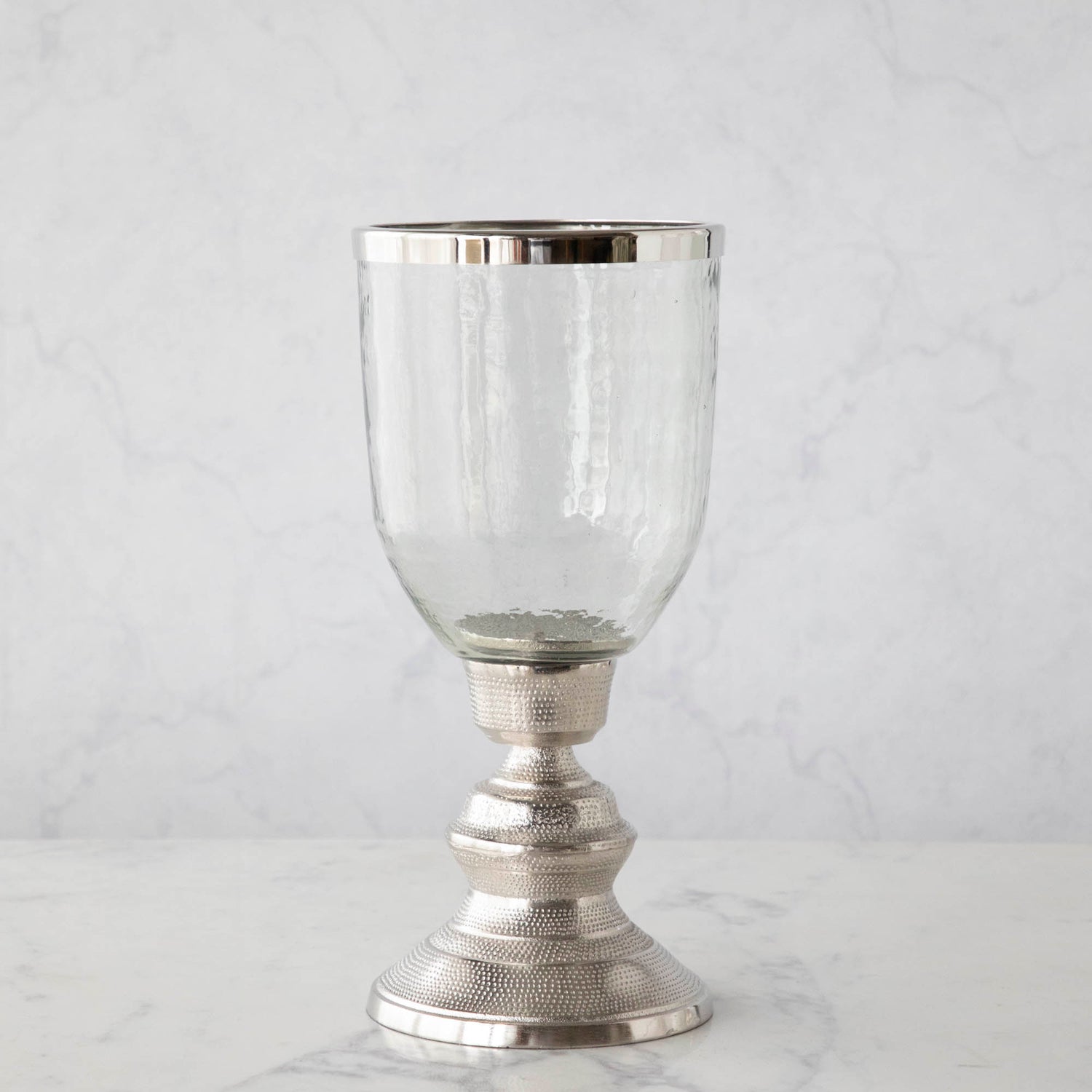 A 14&quot; Candle Hurricane Holder on a marble table.