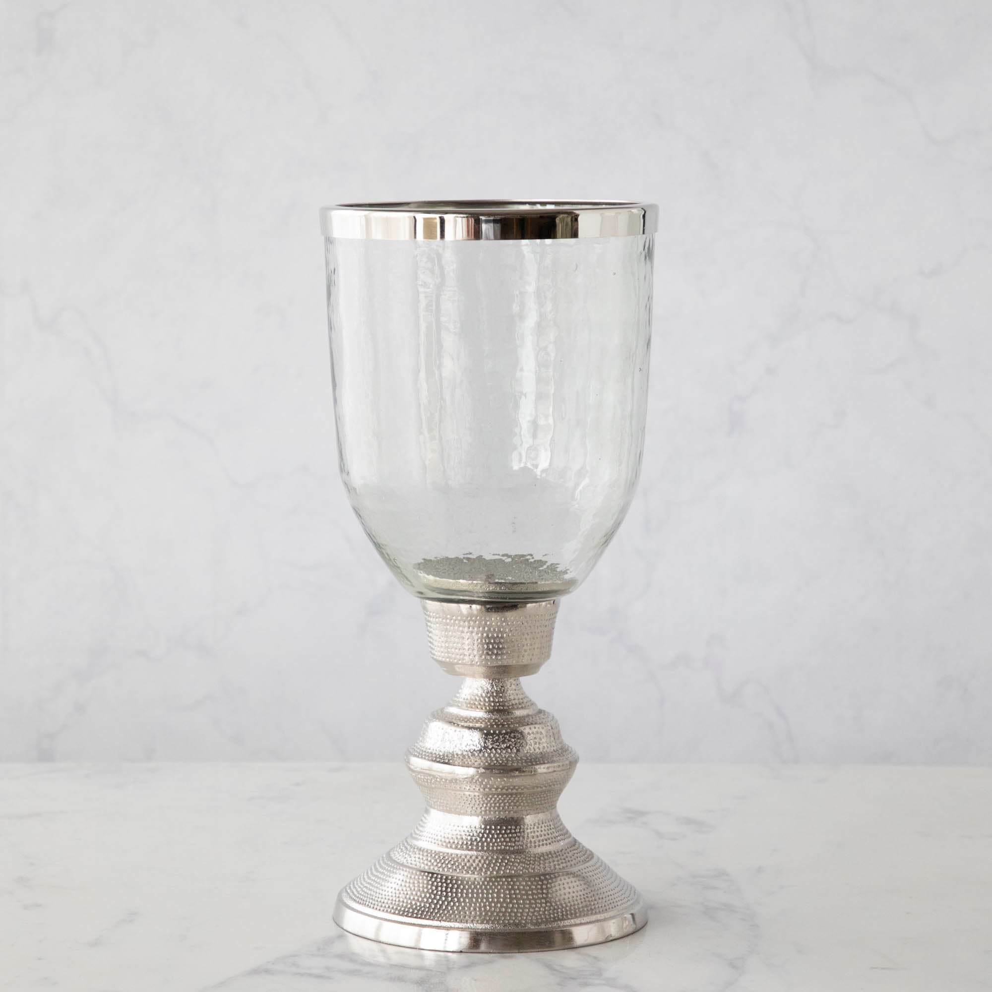 A 14&quot; Candle Hurricane Holder on a marble table.