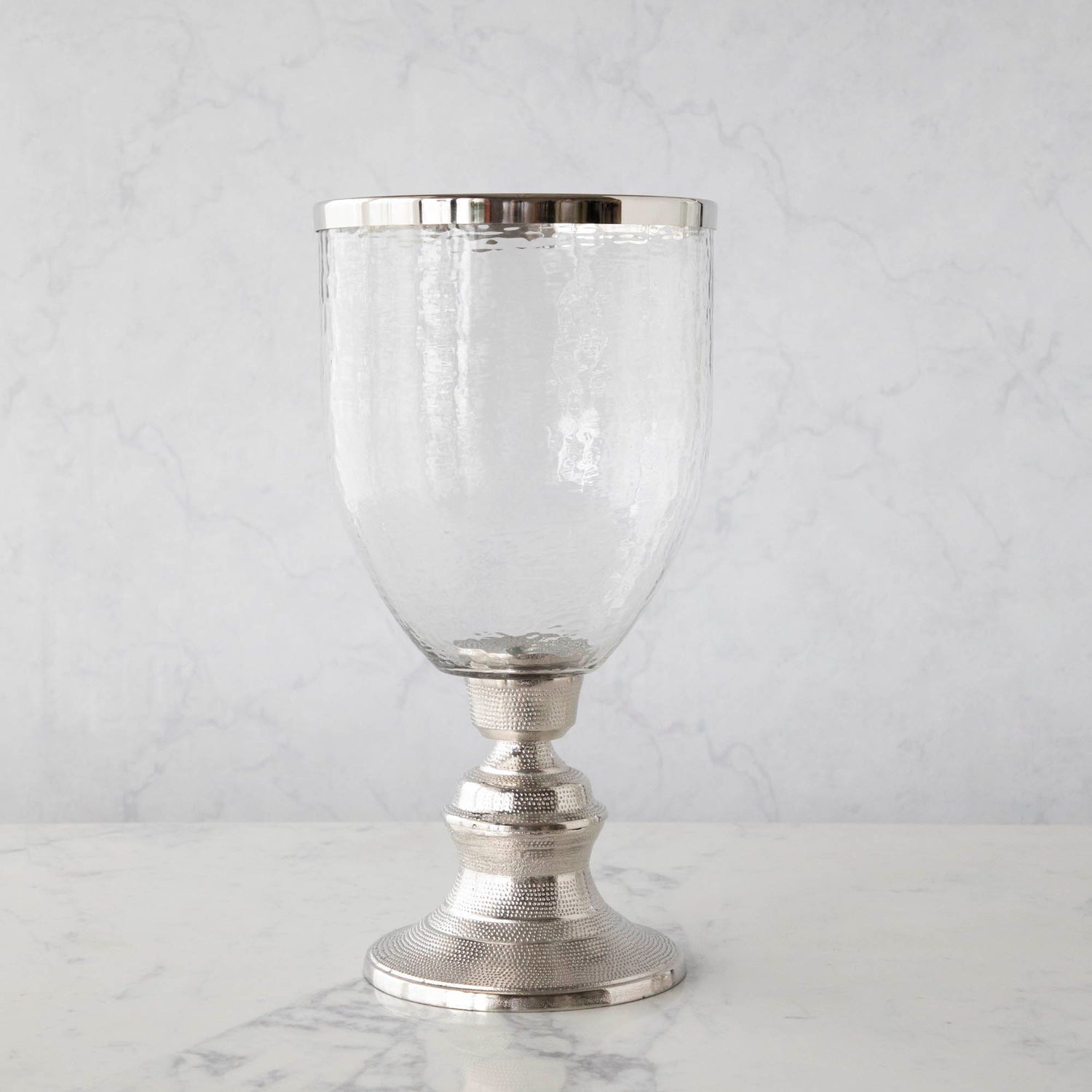 A 17.5&quot; Candle Hurricane Holder on a marble table.
