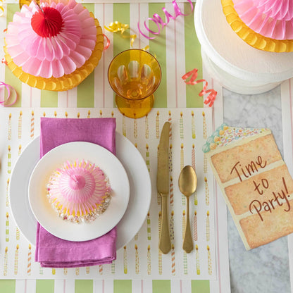 Honeycomb Medium Cupcake on top of dinner plates, styled on a fun, birthday themed table setting.