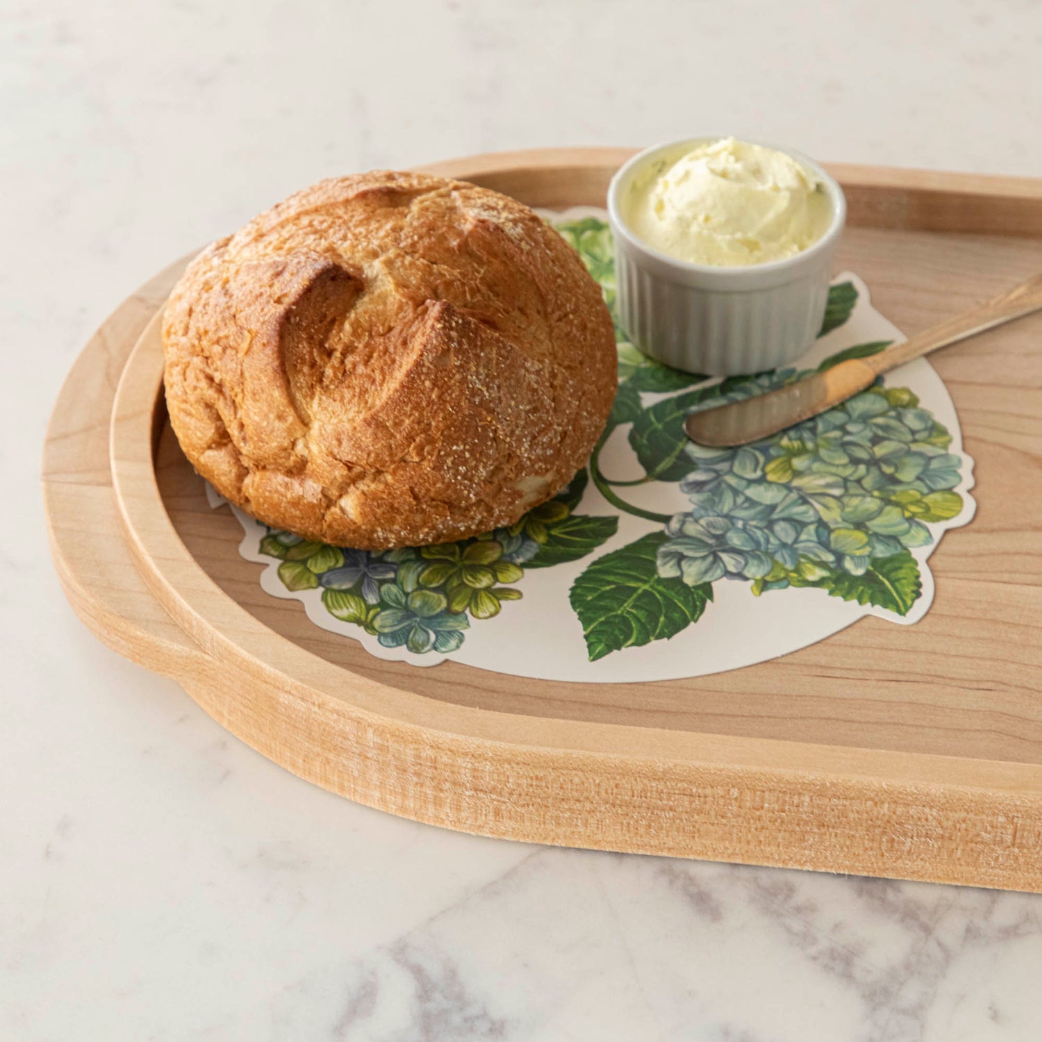 A JK Adams Maple Oval Wooden Serving Tray with food on it.