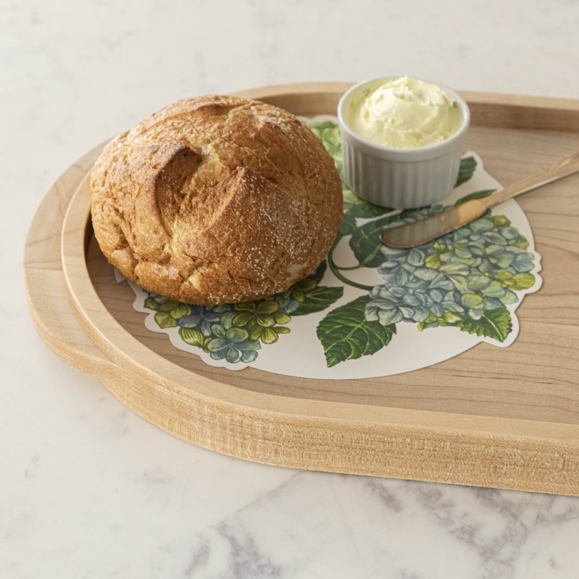 A JK Adams Maple Oval Wooden Serving Tray with food on it.