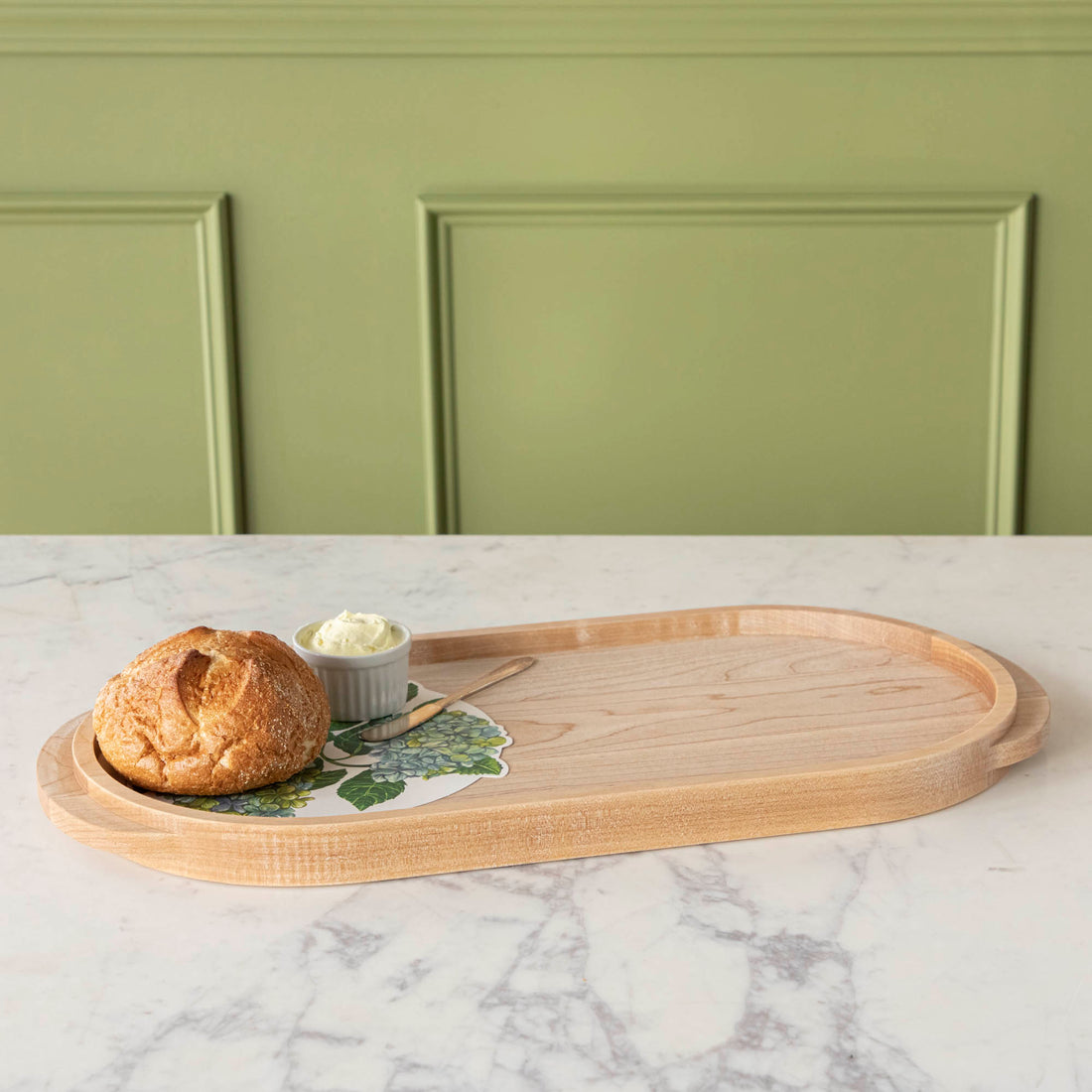 A JK Adams Maple Oval Wooden Serving Tray with food on it.