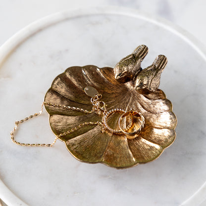 Gilded Perch Pewter Jewelry Dish with jewelry in it.