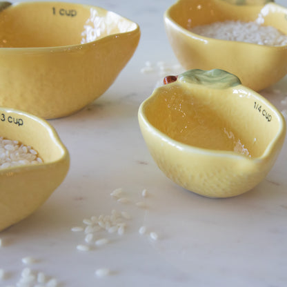 An angled view of the Stoneware Lemon Measuring Cups showing the lips for easy pouring.
