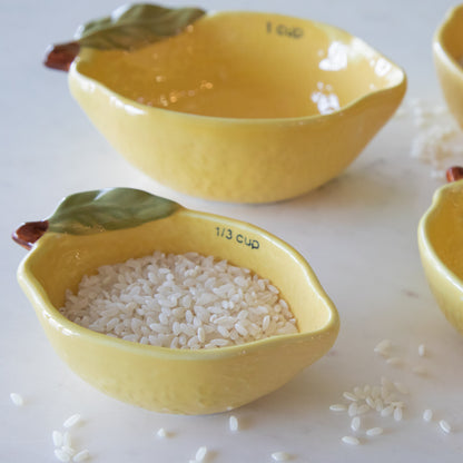 The 1/3 lemon measuring cup with rice inside.