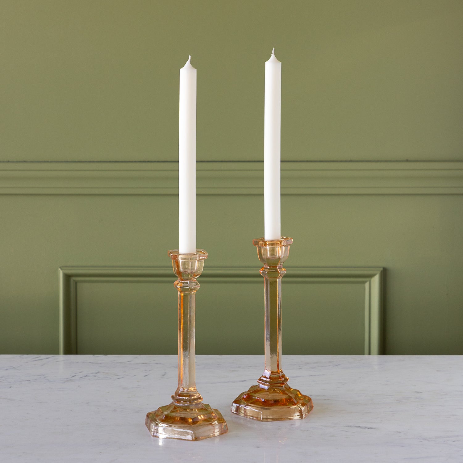 Amber Glass Taper Holders with candles in them.