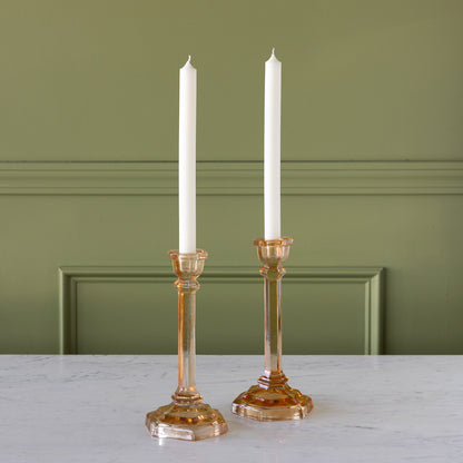 Amber Glass Taper Holders with candles in them.