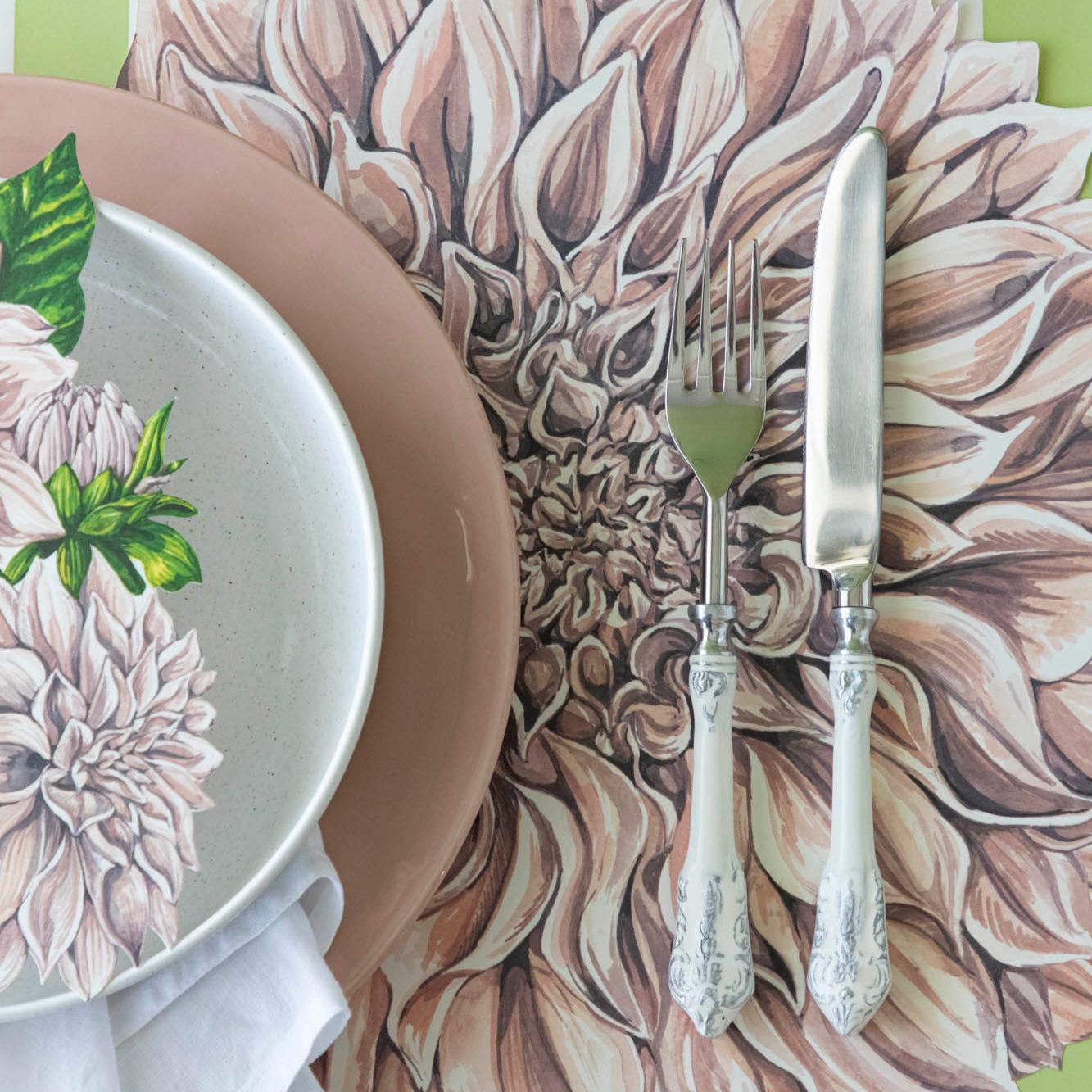 Die-cut Dahlia Placemat under a place setting for one.