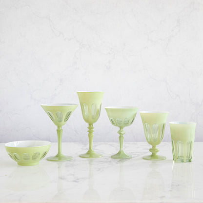 A set of SIR/MADAM Rialto Pale Sage Glasses and a bowl on a marble table.