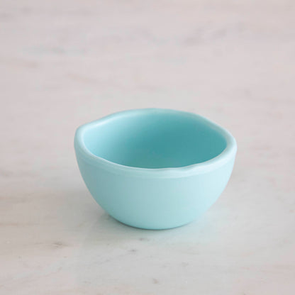 A set of colorful, dishwasher-safe Glitterville Rainbow Melamine Trinket Bowls on a table.