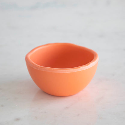 A set of colorful, dishwasher-safe Glitterville Rainbow Melamine Trinket Bowls on a table.