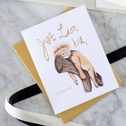 Good Juju Ink cards with black and white ribbon on a table.