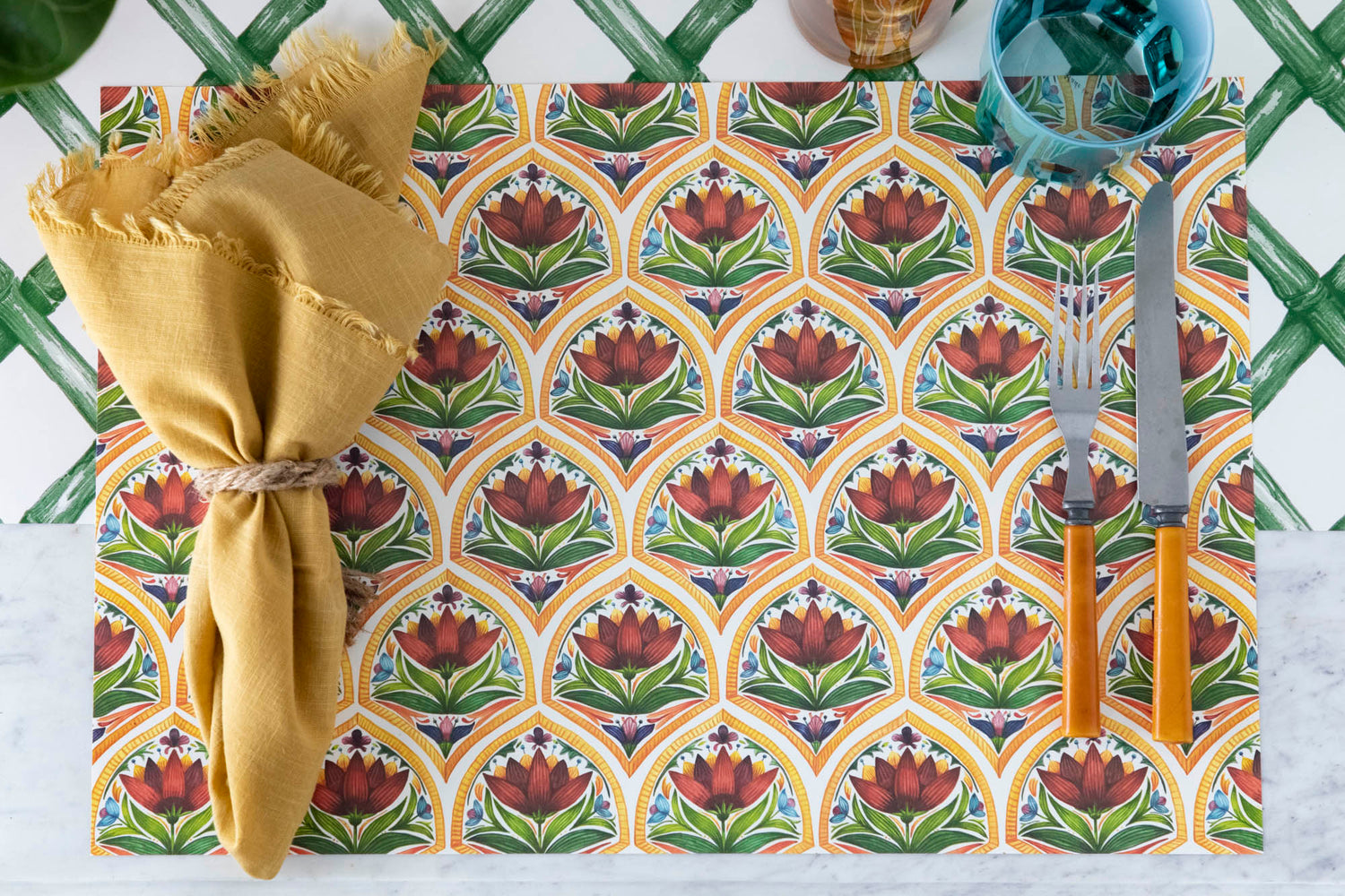 The Fiesta Floral Tile Placemat used in a festive place setting sans plate, from above.