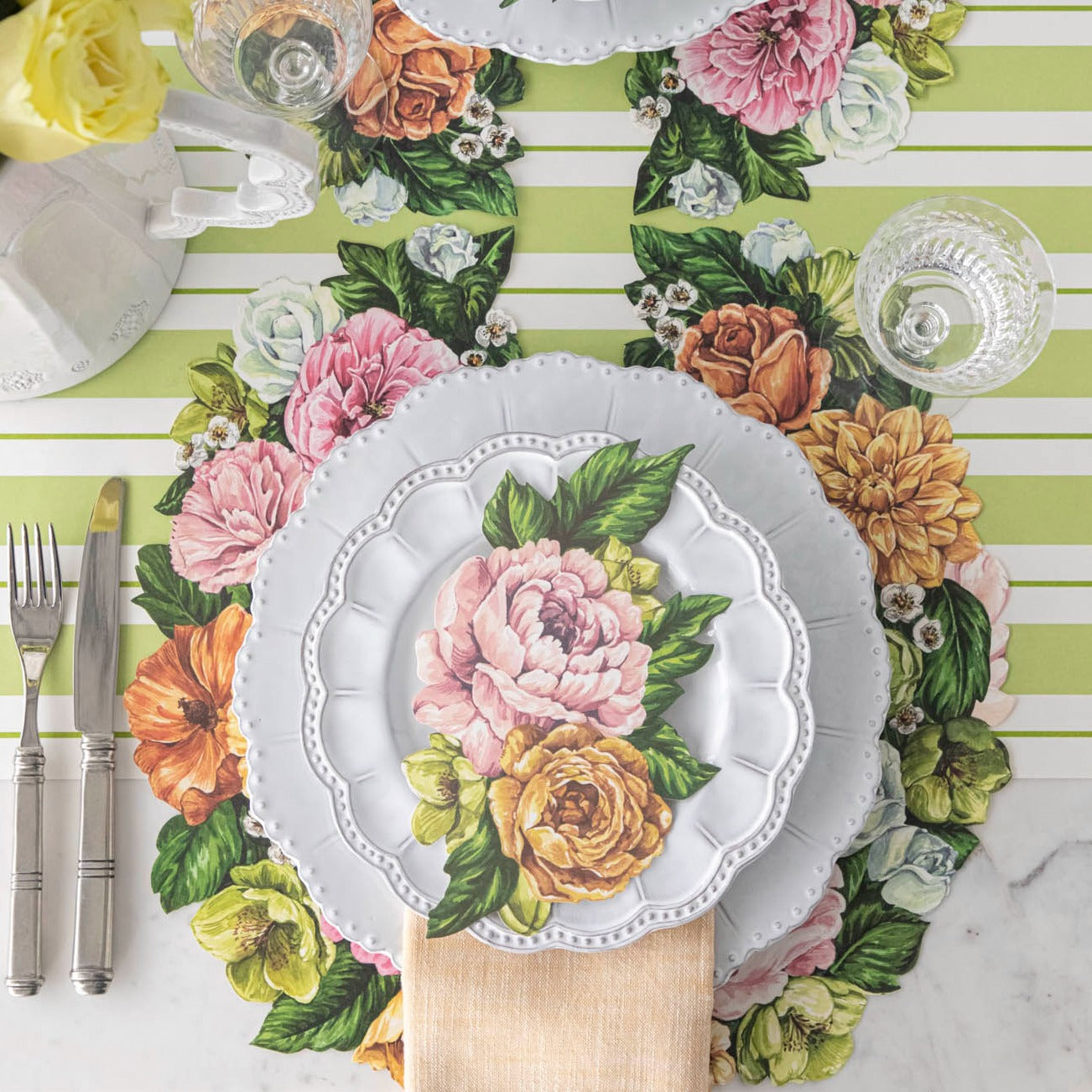 The Die-cut Derby Wreath Placemat under a bright floral place setting, from above.