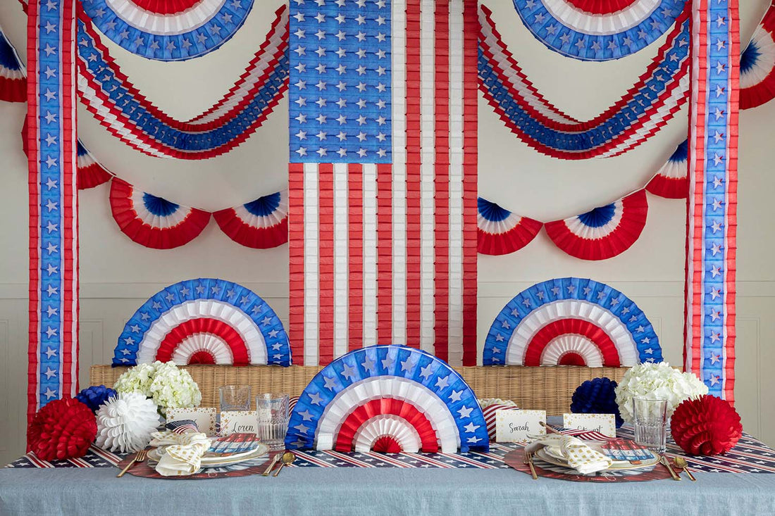 Three Hester &amp; Cook patriotic ruffled balls, set of 3, on a table.