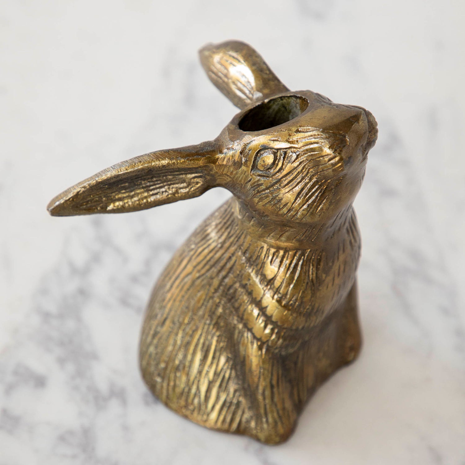 The top of the Halcyon Hare Head Candle Holder showing the hole between its eyes for a taper candle.