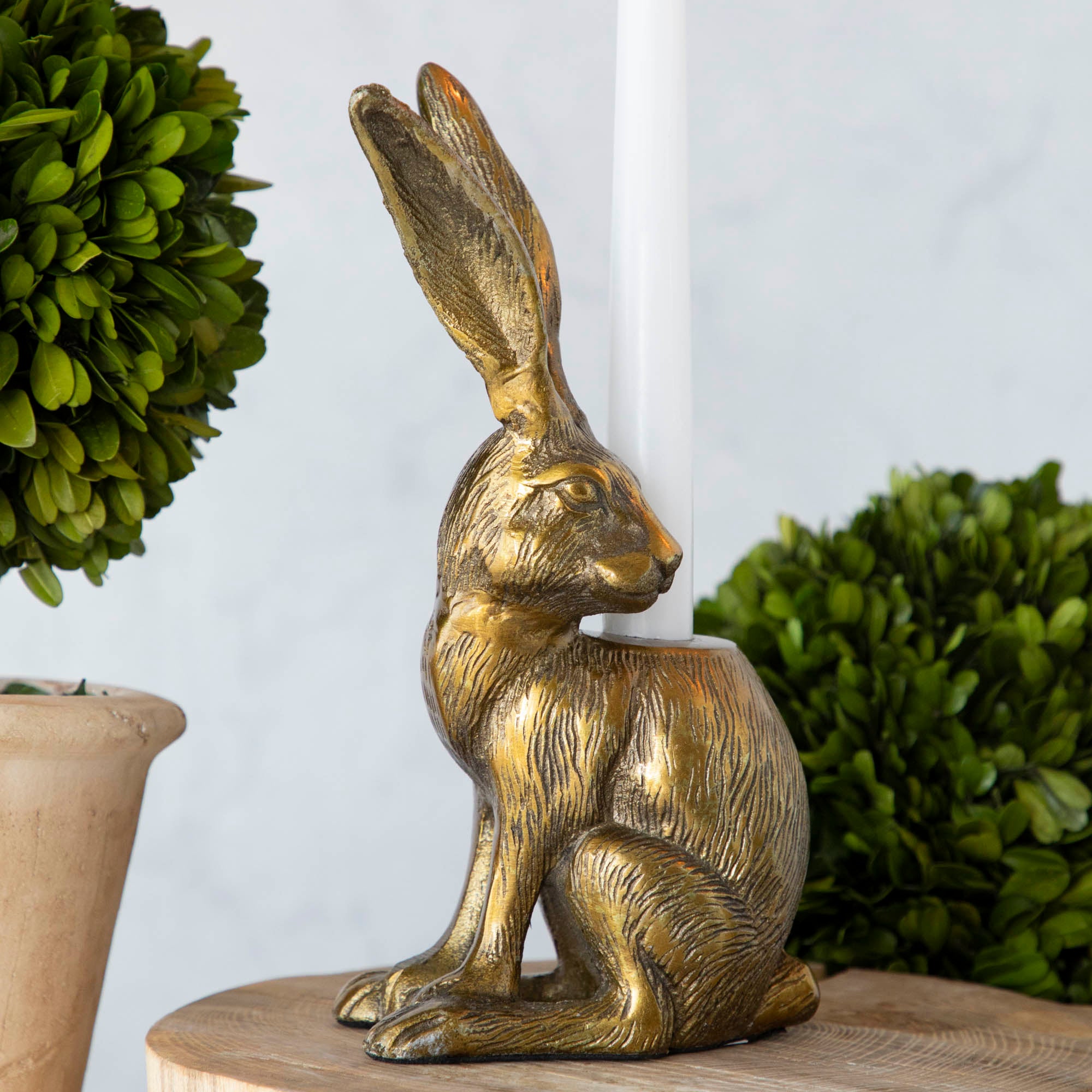 Halcyon Hare Taper Candleholders by Accent Decor on a wooden board.