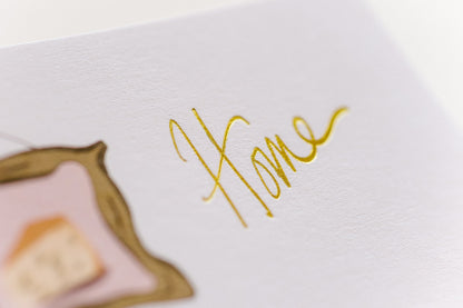 Close up of gold stamped lettering on card. 
