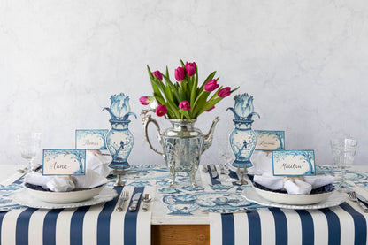 A serene Indigo Meadow place card on a table with buffet labels, flowers, and plates that make guests feel extra special by Hester &amp; Cook.