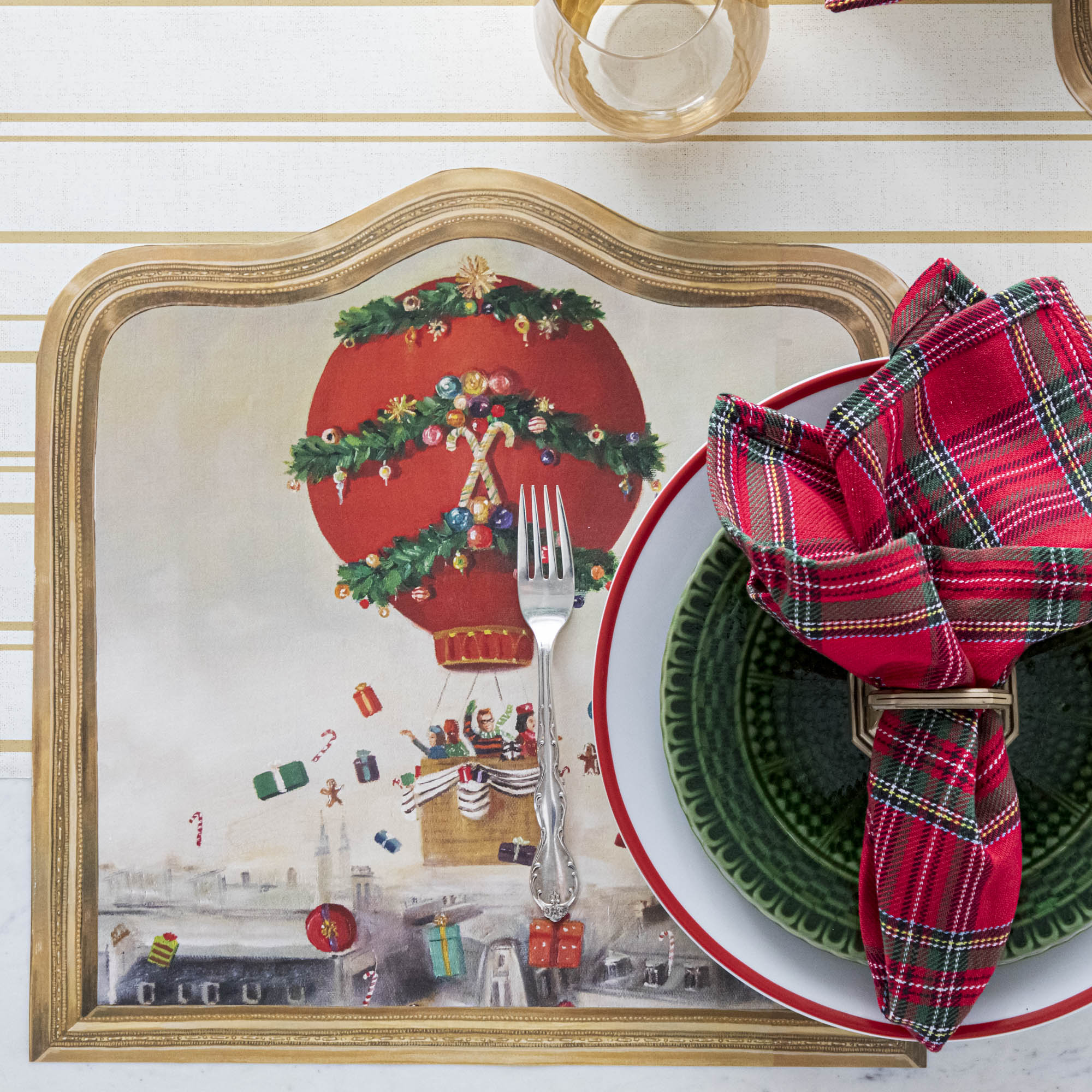 The Die-cut Christmas Balloon Ride Placemat under a festive Christmas-themed place setting, from above.