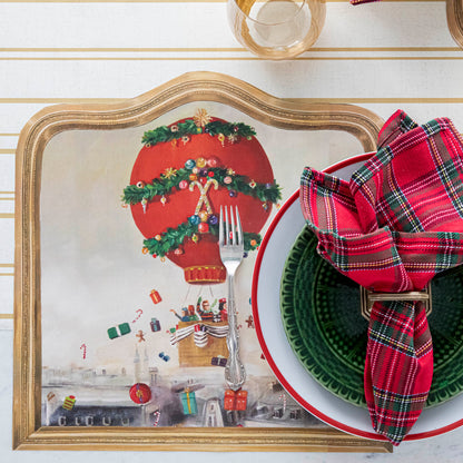 The Die-cut Christmas Balloon Ride Placemat under a festive Christmas-themed place setting, from above.