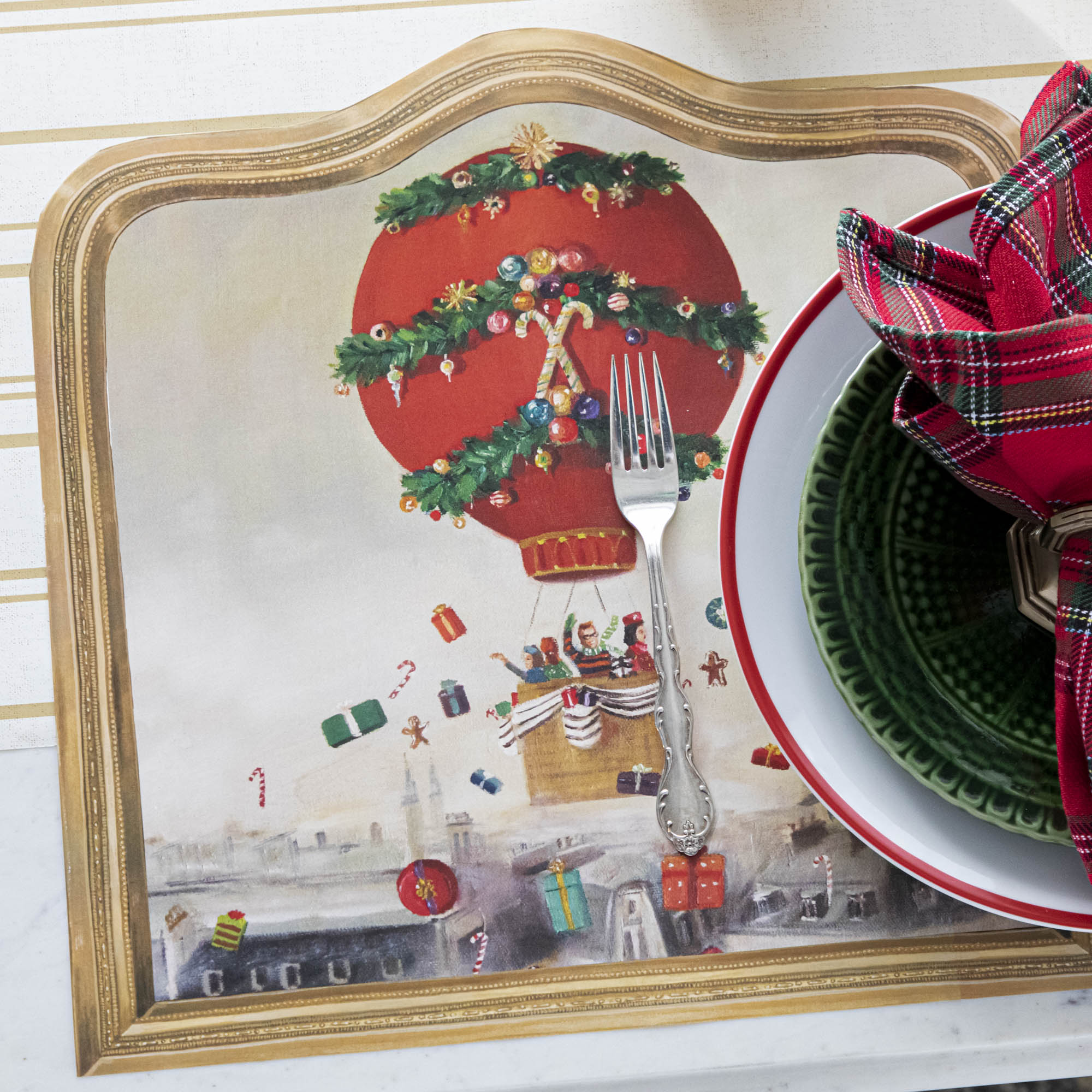 The Die-cut Christmas Balloon Ride Placemat under a festive Christmas-themed place setting.