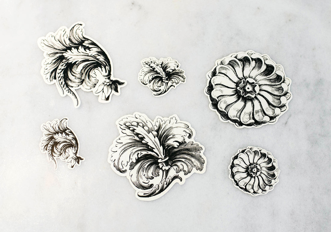 A set of six die-cut, illustrated decorative Serving Papers featuring engraving-style fillagree designs in black on white paper.