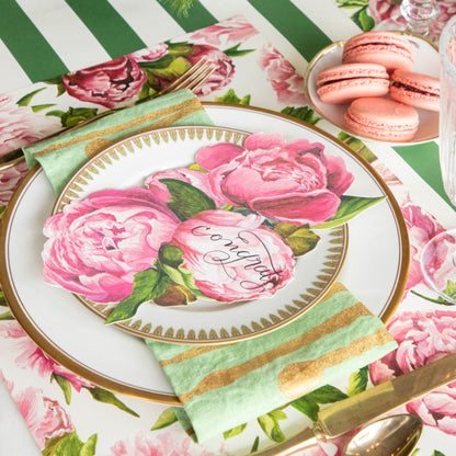 An elegant place setting featuring a Peony Table Accent with &quot;congrats&quot; written on it resting on the plate.