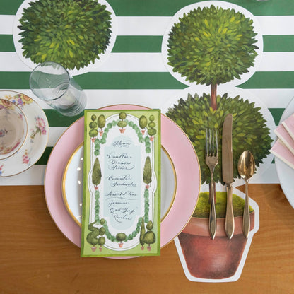 Two Die-cut Topiary Pair Placemats on a table with placemats on a white background. (Brand: Hester &amp; Cook)