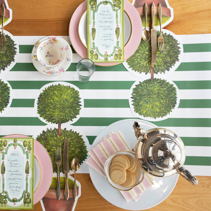 Top-down view of an elegant garden-themed tablescape, featuring Pink &amp; Gold Awning Stripe Guest Napkins.