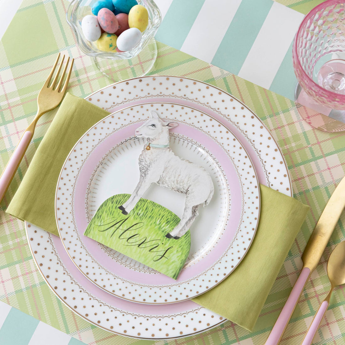 Welcome Little Lamb Place Card with &quot;Alexis&quot; written on it, centered on dinner plates on a place setting for one.