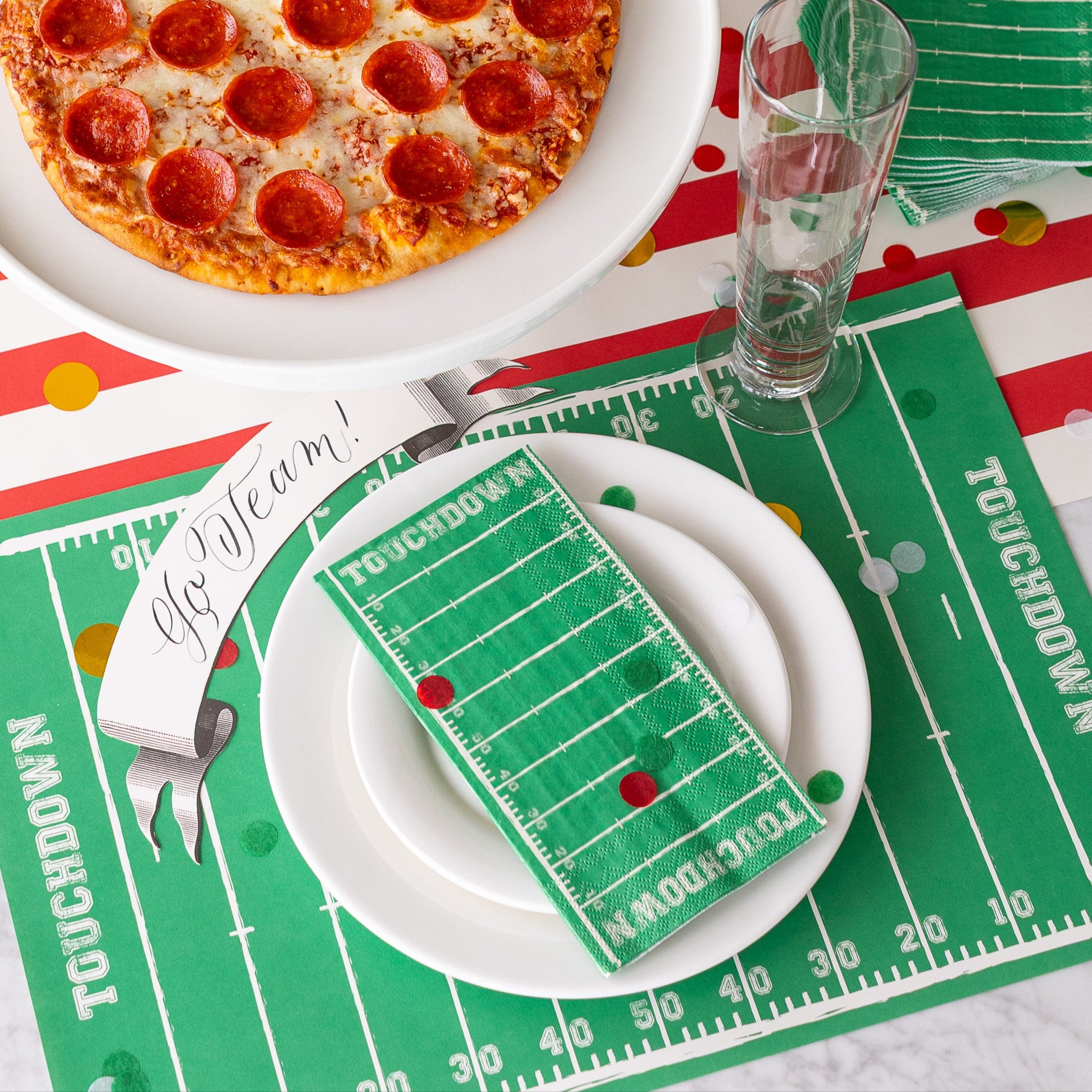 Touchdown Placemat on a sports themed place setting with the Guest Touchdown Napkin resting on the plates.