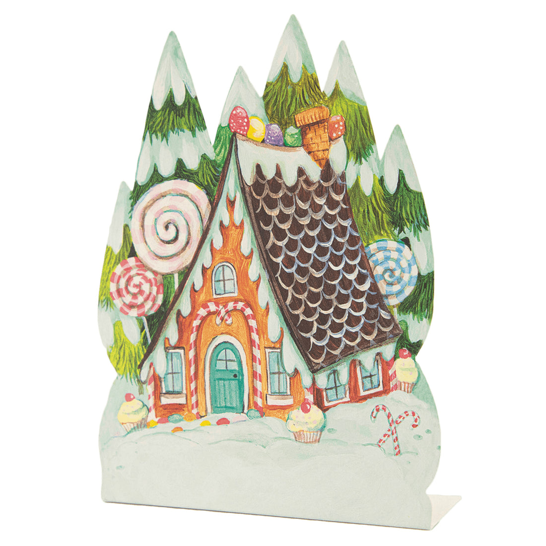 A die-cut, freestanding place card featuring whimsical artwork of a charming gingerbread house with snowy evergreen trees behind it and candy decor all around.
