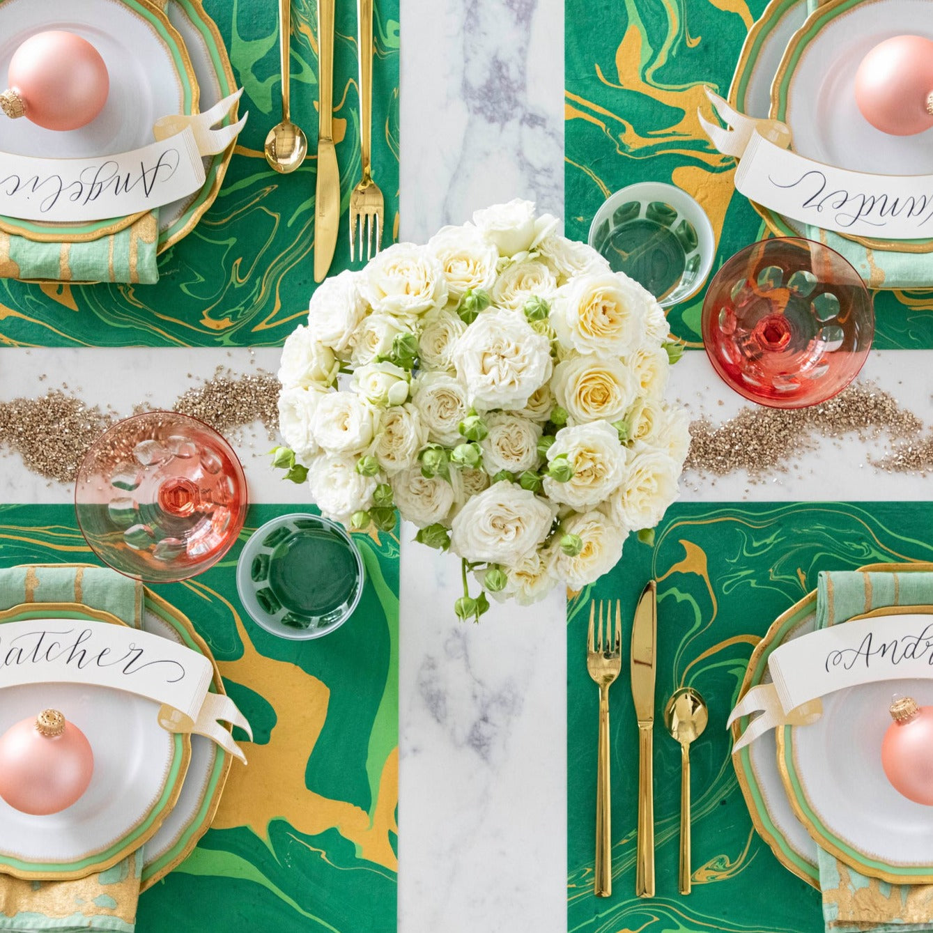 The Green &amp; Gold Vein Marbled Placemat under a festive holiday-themed table setting for four, from above.