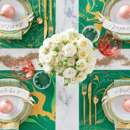 The Green &amp; Gold Vein Marbled Placemat under a festive holiday-themed table setting for four, from above.