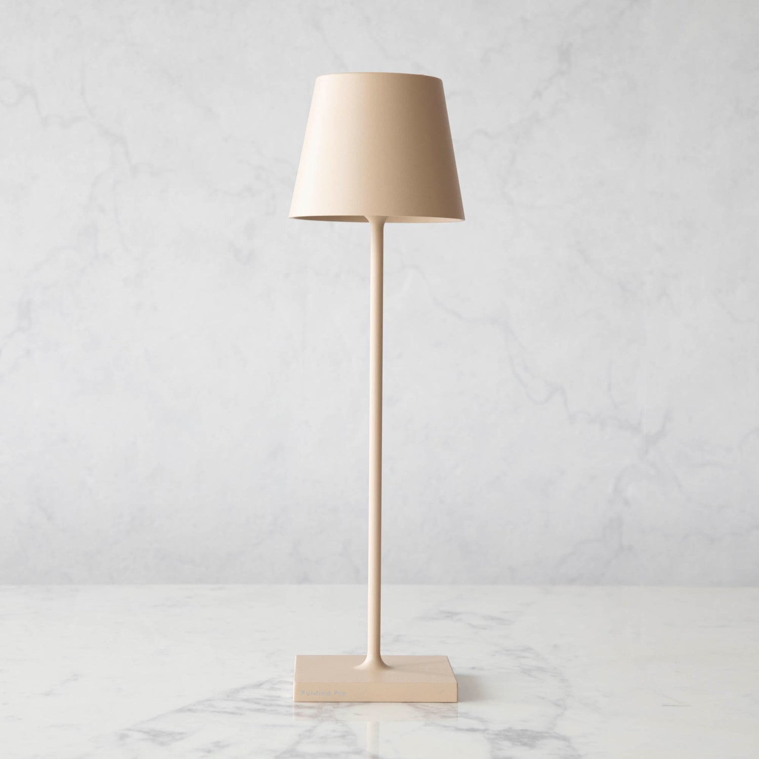 A Sand Cordless Lamp by Zafferano on a table.