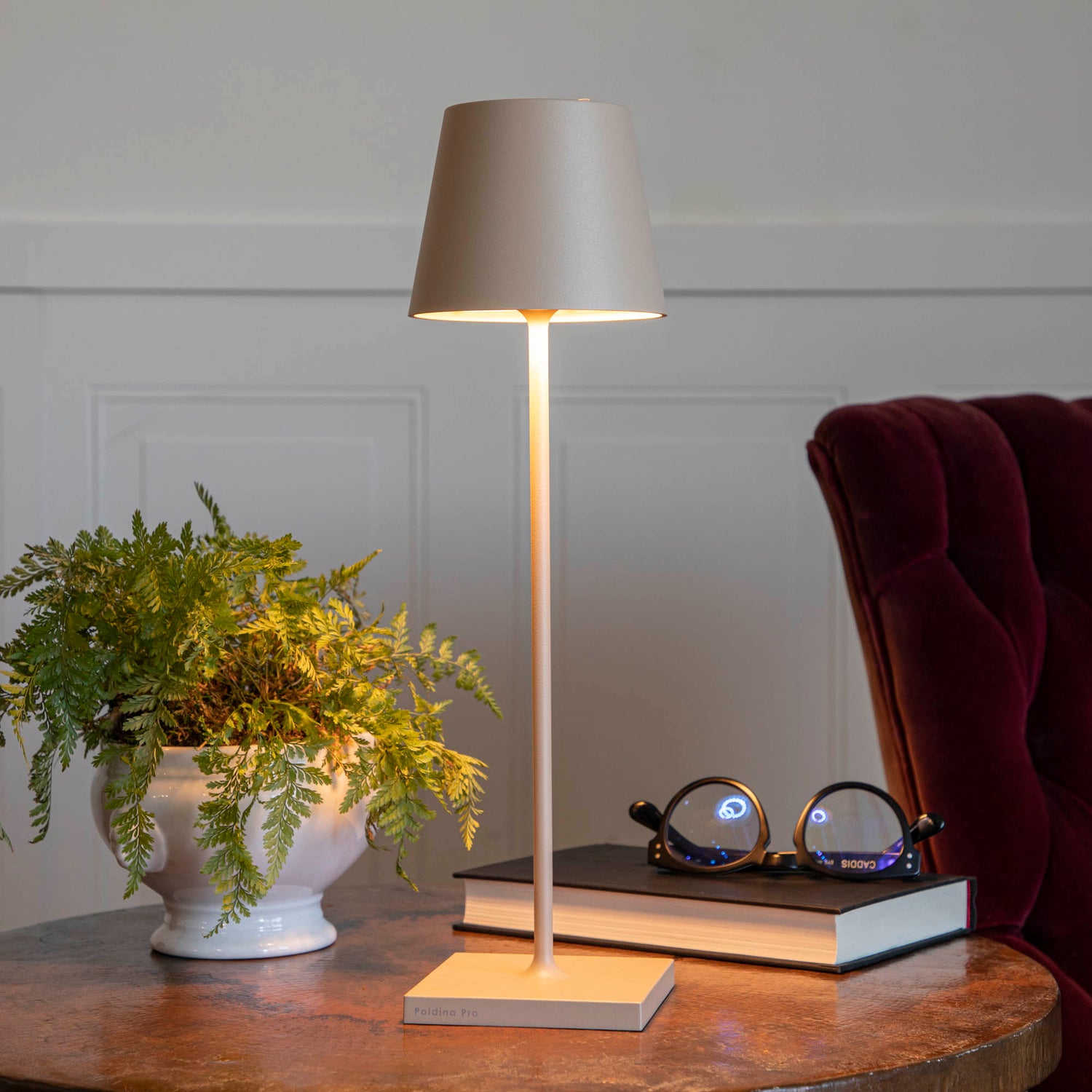 A Sand Cordless Lamp by Zafferano on a table.