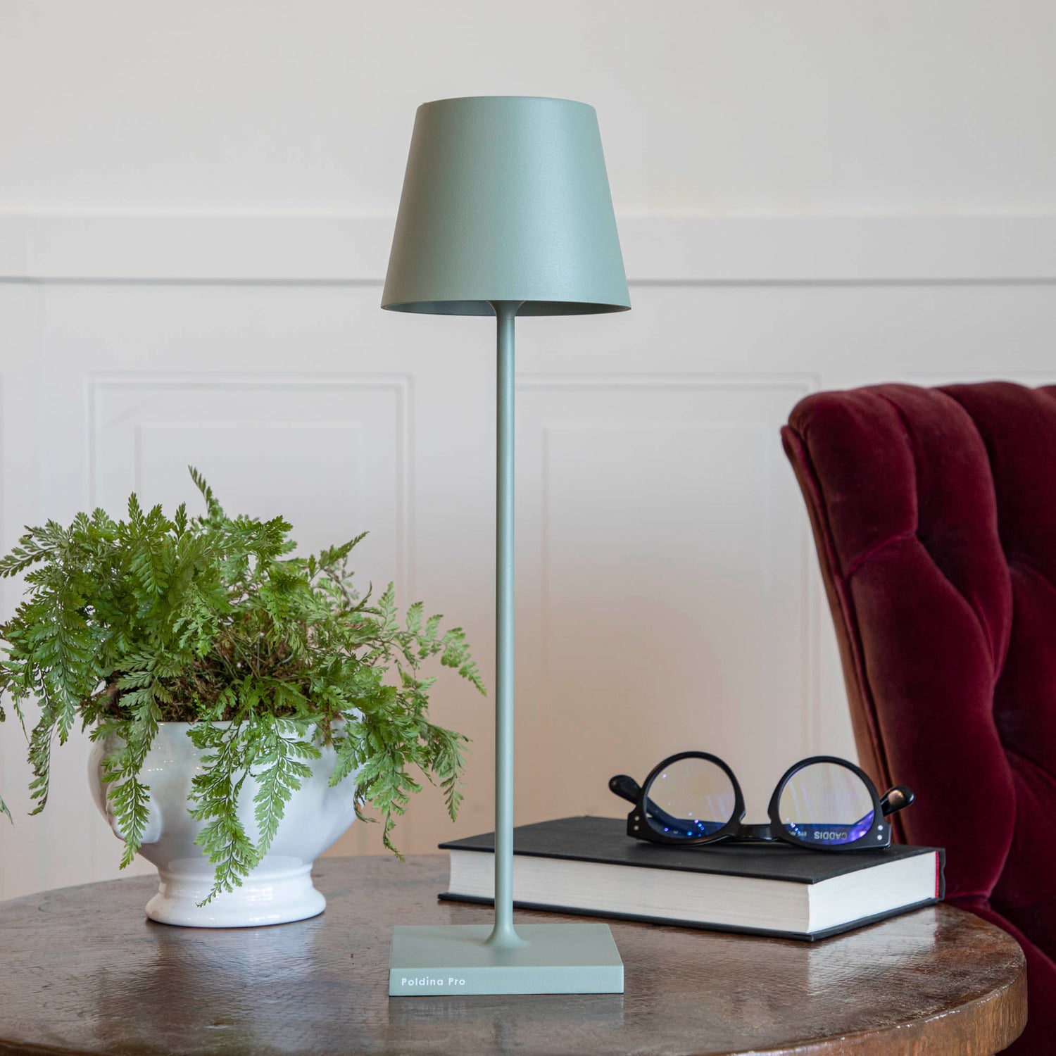 A table setting with place settings and a Zafferano Sage Cordless Lamp.