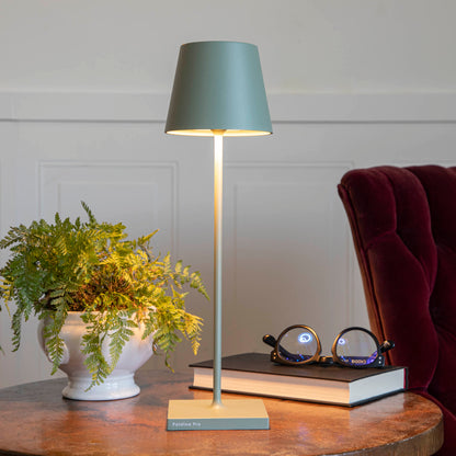 A table setting with place settings and a Zafferano Sage Cordless Lamp.