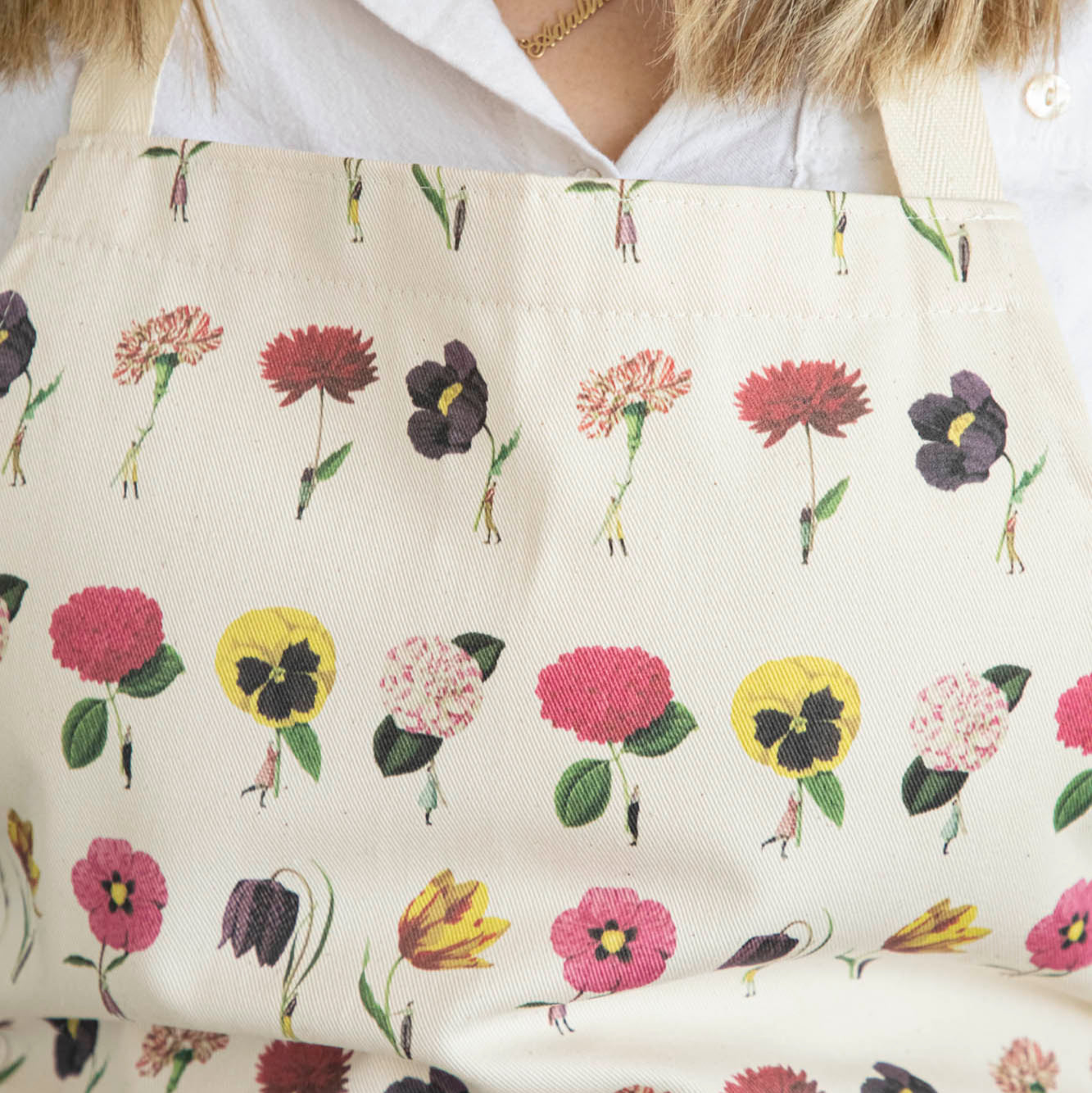 Close-up of a woman wearing the In Bloom Apron by Laura Stoddart.