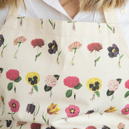 Close-up of a woman wearing the In Bloom Apron by Laura Stoddart.