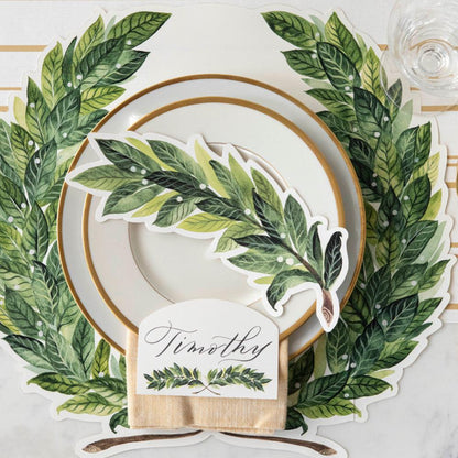 An elegant place setting featuring a Laurel Place Card labeled &quot;Timothy&quot; laying flat on the plate, from above.