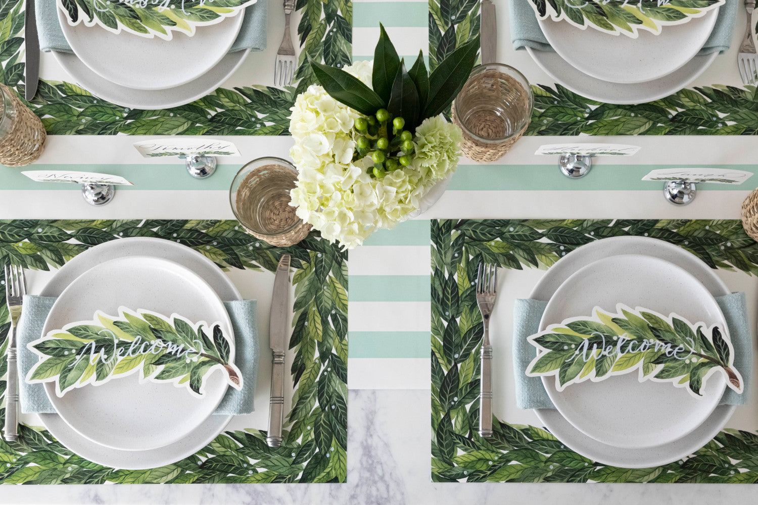A table set with Laurel Placemats and flowers for a wedding by Hester &amp; Cook.