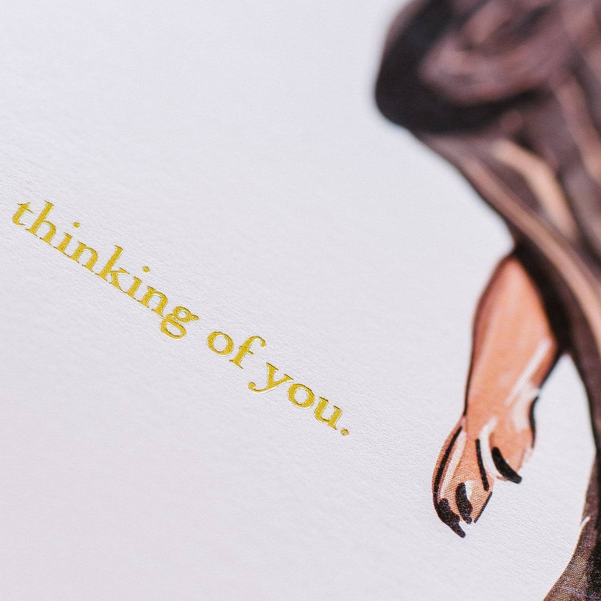 Close up of gold type on card.