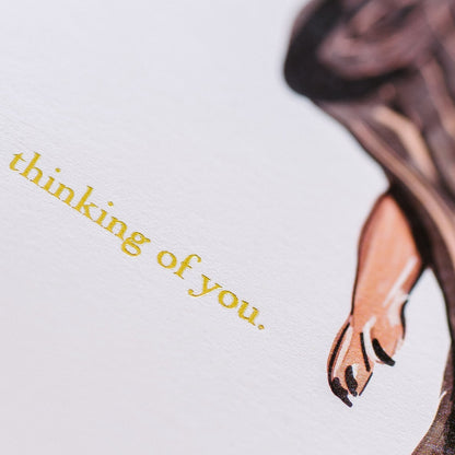 Close up of gold type on card.