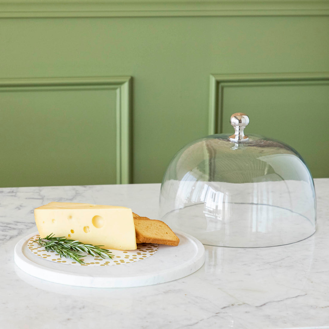 Chocolate muffins under a Bidk Home Marble &amp; Glass Food Dome with Knob, 11.5&quot; Diameter, presented on a white marble plate.