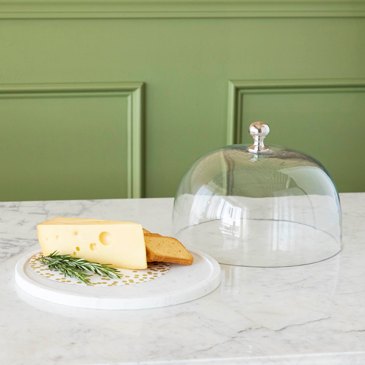 Chocolate muffins under a Bidk Home Marble &amp; Glass Food Dome with Knob, 11.5&quot; Diameter, presented on a white marble plate.