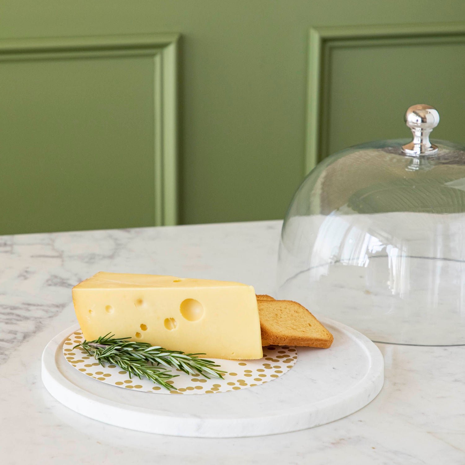 Chocolate muffins under a Bidk Home Marble &amp; Glass Food Dome with Knob, 11.5&quot; Diameter, presented on a white marble plate.